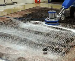 Professional rug cleaning with a rotary floor machine and shampoo foam, deep-cleaning an area rug, in Orange, CA.
